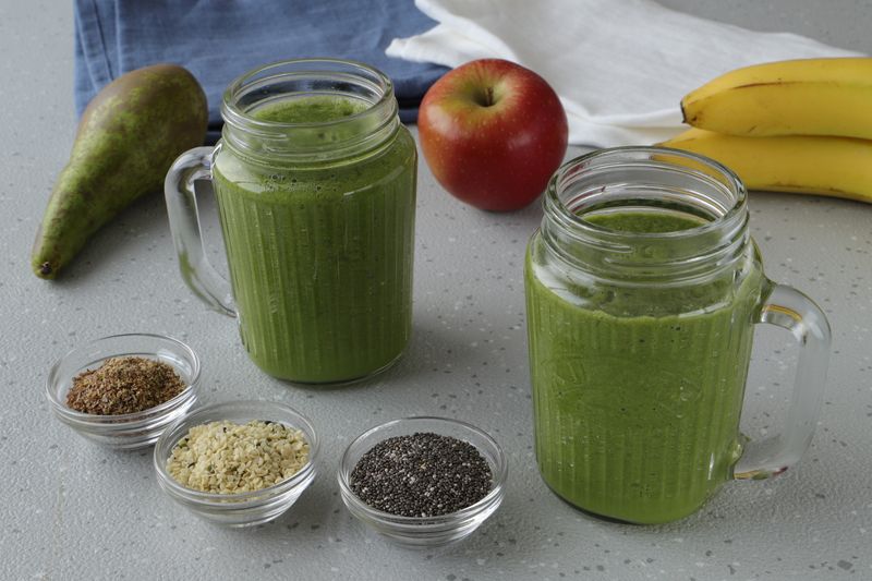 Green detox smoothie with spinach kale and mango